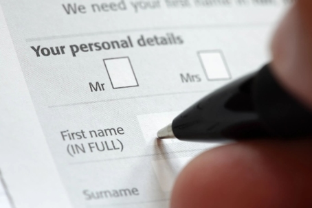 Person completing a form for a name change after divorce