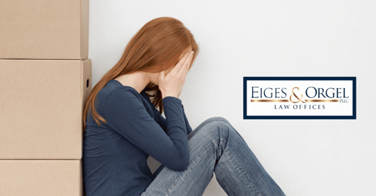 girl with hands in face surrounded by boxes