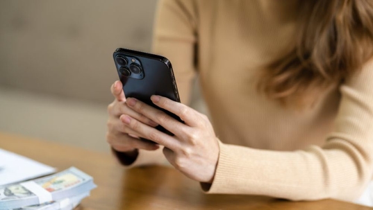Divorced woman checking her ex-spouse’s social media accounts