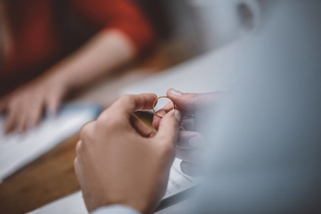 A man holding his wedding ring after divorce